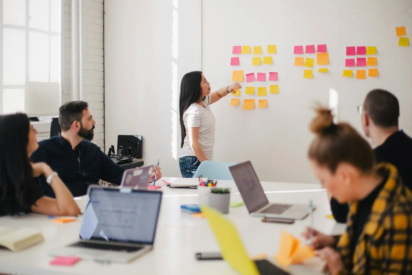 A team reviewing a campaign wall covered with notes