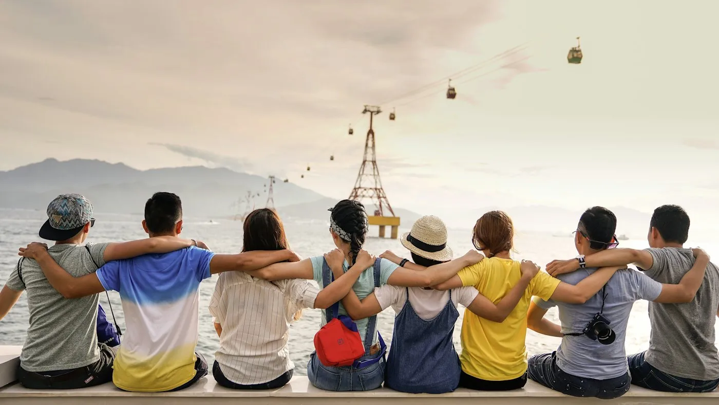 Friends sitting together and looking out over the water