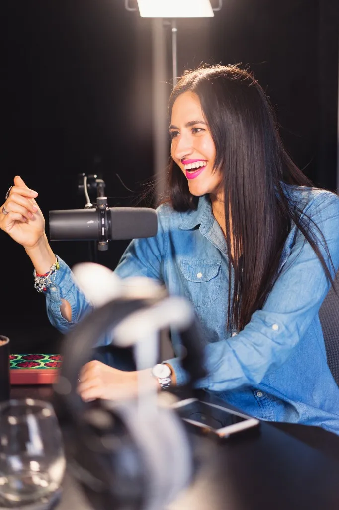 Host smiling at a studio microphone